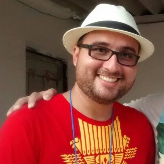 Foto do rosto de colaborador da Pitang de barba, óculos e chapéu